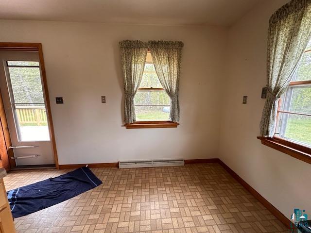 5960 Evergreen Rd, Aurora, MN 55705 - foyer with a baseboard heating unit, healthy amount of natural light, baseboards, and brick patterned flooring