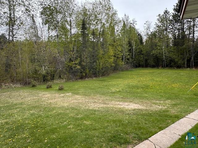 5960 Evergreen Rd, Aurora, MN 55705 - view of green lawn featuring a view of trees