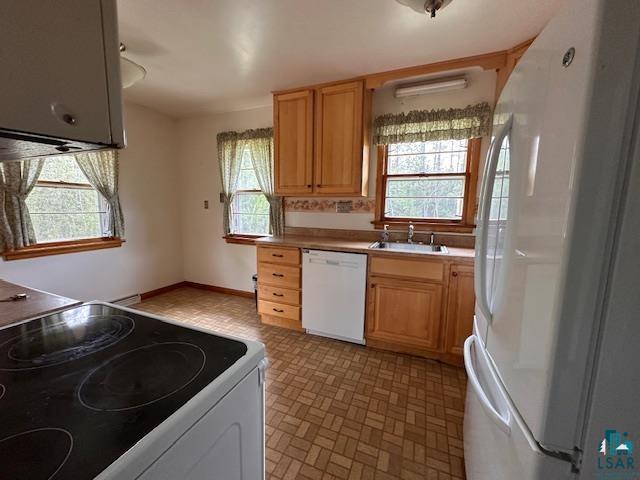 5960 Evergreen Rd, Aurora, MN 55705 - kitchen with white appliances, a sink, and light countertops