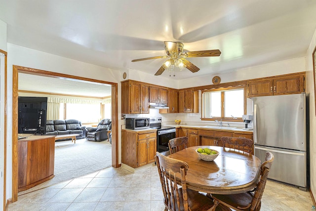 405 10th Ave, Two Harbors, MN 55616 - kitchen with stainless steel appliances, a sink, light countertops, ceiling fan, and brown cabinets