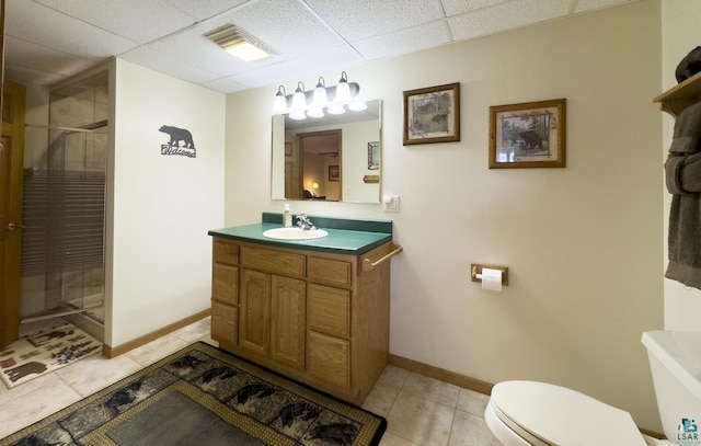 1880 S Everett Rd, Tower, MN 55790 - bathroom featuring toilet, vanity, baseboards, a stall shower, and a paneled ceiling