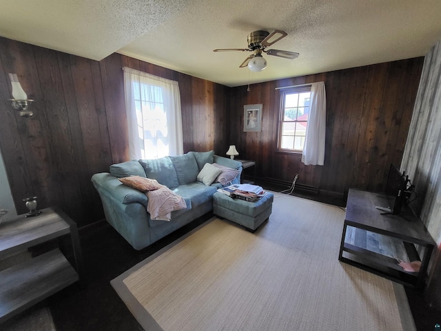 111 E Nebraska Ave, Gilbert, MN 55741 - living room featuring a textured ceiling, ceiling fan, and wooden walls