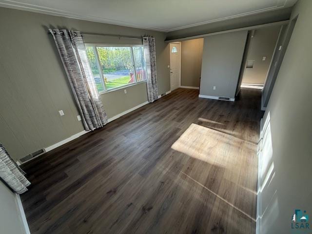 710 N Boundary Ave, Duluth, MN 55810 - unfurnished living room featuring baseboards, wood finished floors, ornamental molding, and a baseboard heating unit