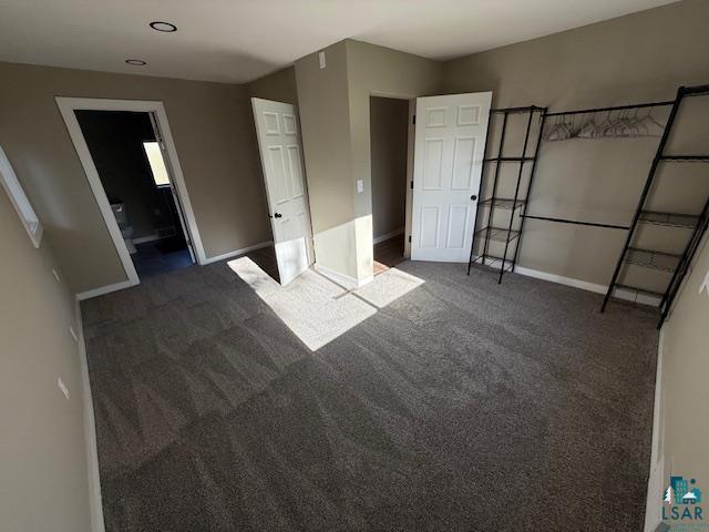 710 N Boundary Ave, Duluth, MN 55810 - unfurnished bedroom with baseboards, carpet floors, and ensuite bathroom