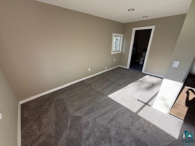 710 N Boundary Ave, Duluth, MN 55810 - spare room with baseboards and dark carpet