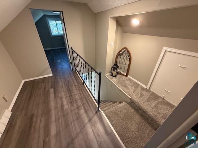 710 N Boundary Ave, Duluth, MN 55810 - stairway featuring wood finished floors, vaulted ceiling, and baseboards