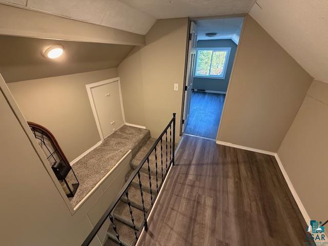 710 N Boundary Ave, Duluth, MN 55810 - hallway featuring an upstairs landing, wood finished floors, vaulted ceiling, and baseboards