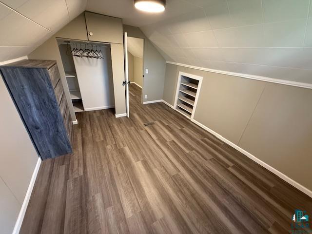 710 N Boundary Ave, Duluth, MN 55810 - bonus room with dark wood-style floors, vaulted ceiling, and baseboards