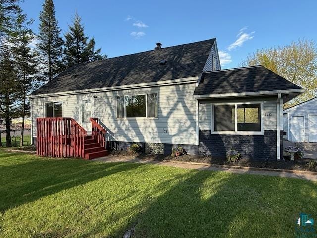 710 N Boundary Ave, Duluth, MN 55810 - rear view of property with a yard and a shingled roof