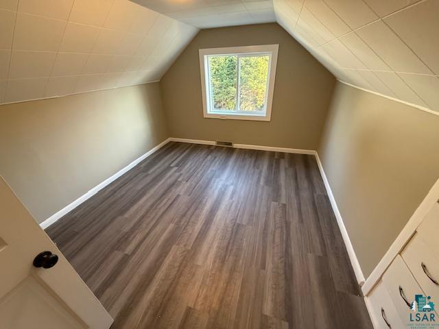 710 N Boundary Ave, Duluth, MN 55810 - bonus room with dark wood finished floors, baseboards, and lofted ceiling