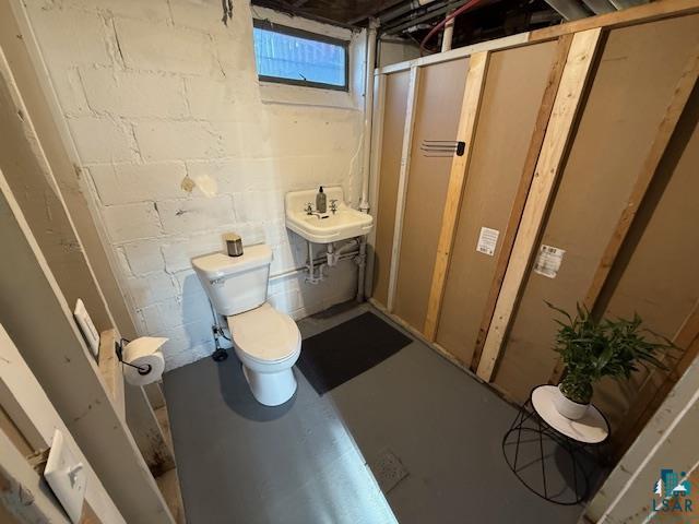 710 N Boundary Ave, Duluth, MN 55810 - bathroom featuring toilet, concrete flooring, and a sink