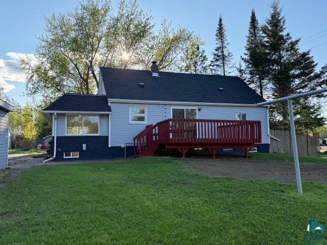 710 N Boundary Ave, Duluth, MN 55810 - back of property with a deck, a lawn, a chimney, and a shingled roof