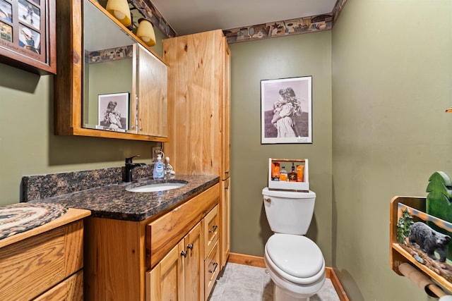 8845 Pequaywan Lake Rd, Duluth, MN 55803 - bathroom with vanity, toilet, baseboards, and tile patterned floors