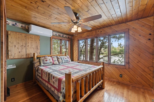 8845 Pequaywan Lake Rd, Duluth, MN 55803 - bedroom with a wall mounted air conditioner, multiple windows, wooden ceiling, wood-type flooring, and wood walls