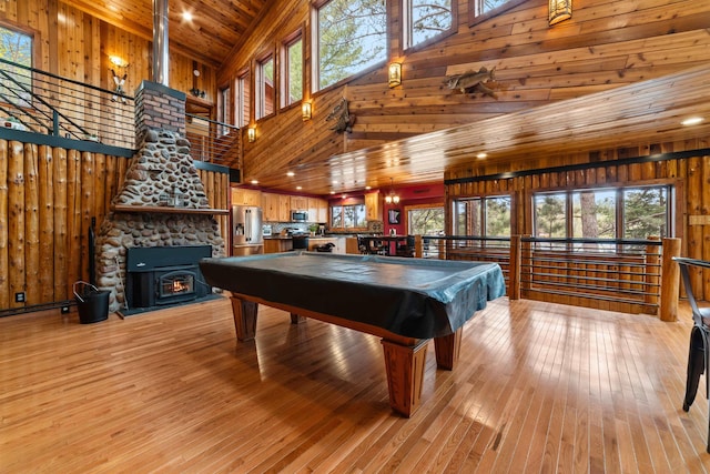 8845 Pequaywan Lake Rd, Duluth, MN 55803 - rec room with high vaulted ceiling, wooden walls, wood ceiling, light wood-style flooring, and healthy amount of natural light