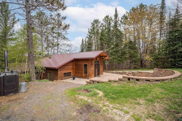 8845 Pequaywan Lake Rd, Duluth, MN 55803 - view of side of home featuring a deck, metal roof, and a yard