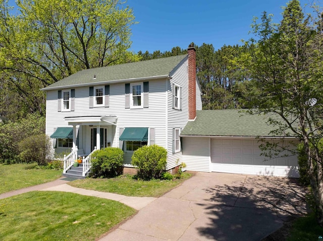 1205 Summit Ave, Cloquet, MN 55720 - view of front of house featuring an attached garage, a chimney, a front yard, concrete driveway, and a shingled roof