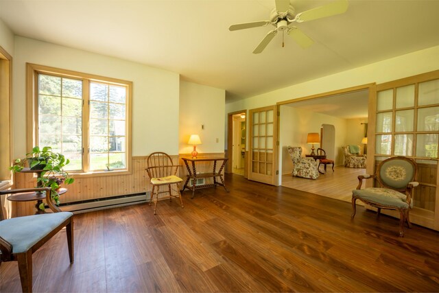 1205 Summit Ave, Cloquet, MN 55720 - living area featuring wood finished floors, french doors, a baseboard radiator, and ceiling fan