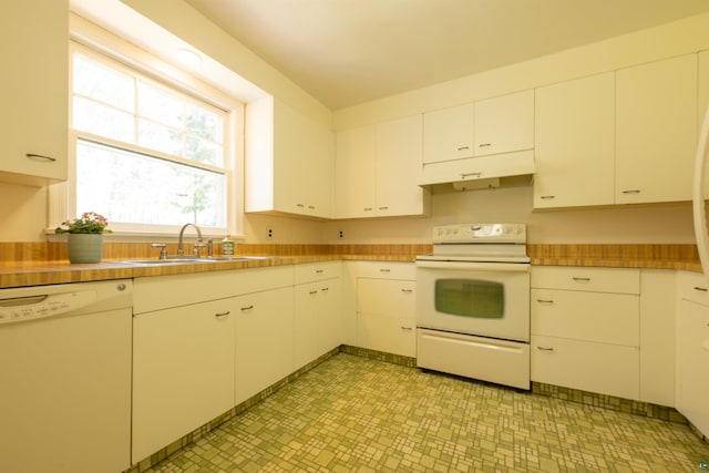 1205 Summit Ave, Cloquet, MN 55720 - kitchen with white appliances, a sink, under cabinet range hood, light flooring, and light countertops