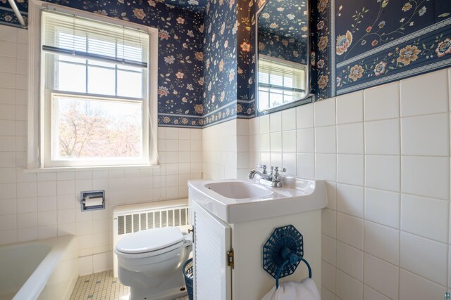 1205 Summit Ave, Cloquet, MN 55720 - full bath featuring tile walls, radiator, wallpapered walls, toilet, and vanity