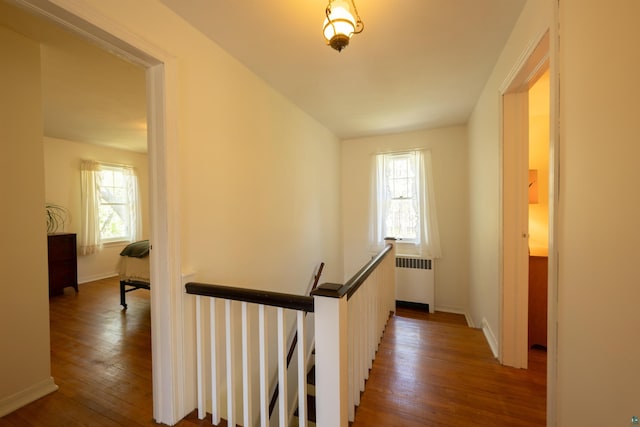 1205 Summit Ave, Cloquet, MN 55720 - hall featuring radiator, an upstairs landing, wood-type flooring, and baseboards