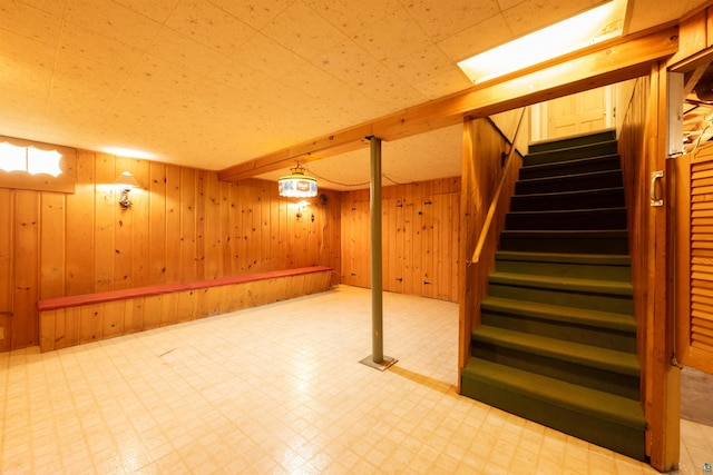 1205 Summit Ave, Cloquet, MN 55720 - finished below grade area featuring tile patterned floors, stairs, and wood walls