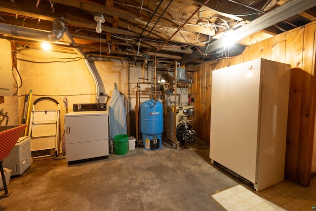 1205 Summit Ave, Cloquet, MN 55720 - unfinished below grade area featuring washer / clothes dryer, a water pressure tank, a heating unit, and freestanding refrigerator