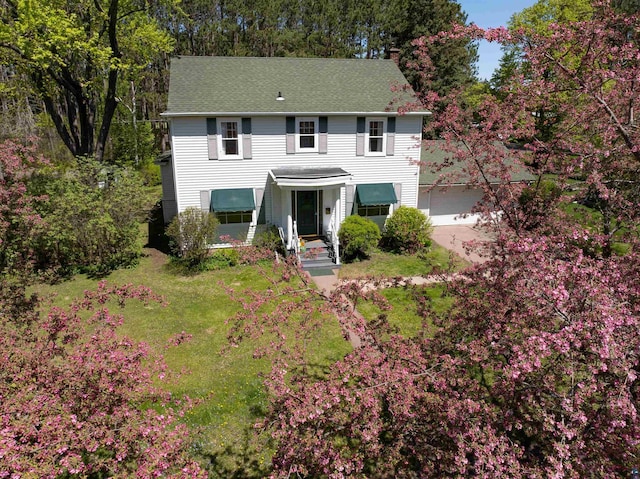 1205 Summit Ave, Cloquet, MN 55720 - colonial home featuring a chimney, a front lawn, driveway, and a garage