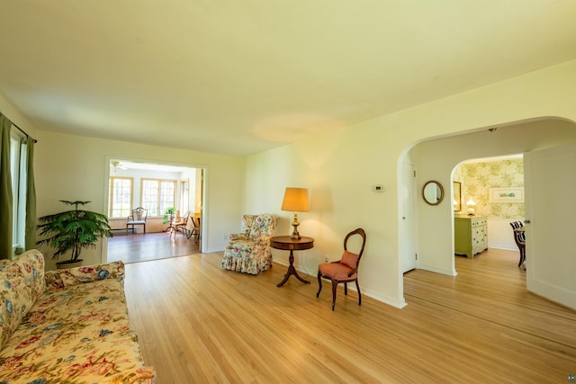 1205 Summit Ave, Cloquet, MN 55720 - living area with arched walkways, light wood finished floors, and baseboards
