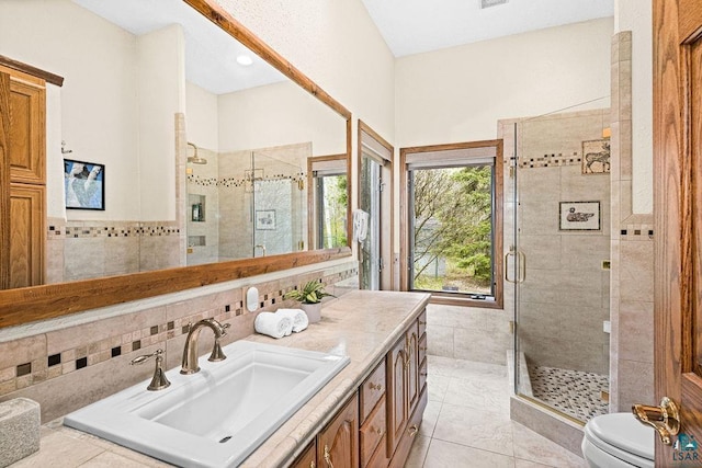 5491 N Shore Dr, Duluth, MN 55804 - full bath featuring a stall shower, tile walls, vanity, and toilet