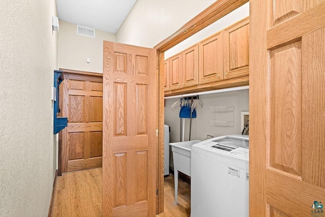 5491 N Shore Dr, Duluth, MN 55804 - laundry room featuring washer / clothes dryer, light wood-style floors, and cabinet space