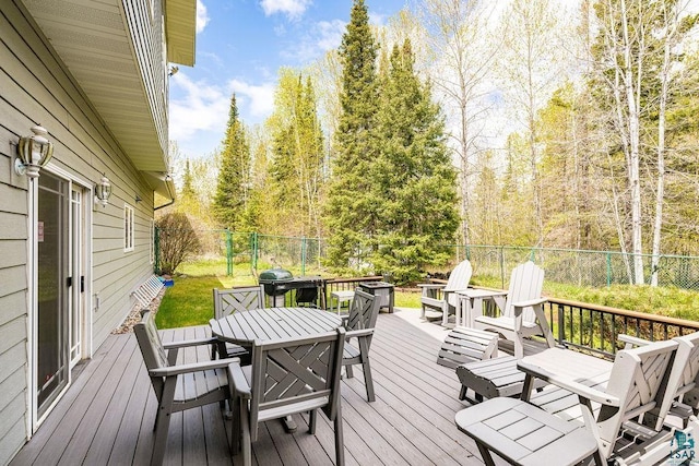 5491 N Shore Dr, Duluth, MN 55804 - wooden deck featuring outdoor dining area and a fenced backyard