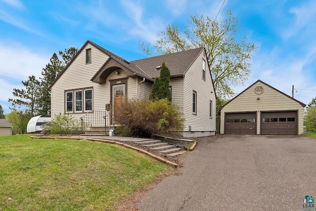 2120 Carlton Ave, Cloquet, MN 55720 - view of front of home with an outbuilding, a front lawn, and a detached garage