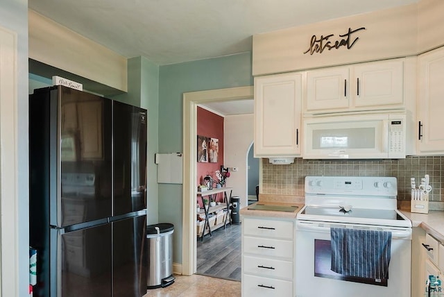 2120 Carlton Ave, Cloquet, MN 55720 - kitchen featuring white appliances, light countertops, tasteful backsplash, white cabinets, and light tile patterned flooring