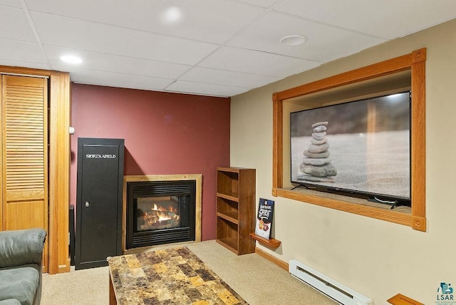2120 Carlton Ave, Cloquet, MN 55720 - carpeted living room with a baseboard heating unit, a glass covered fireplace, a paneled ceiling, and recessed lighting