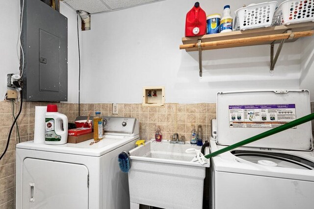 5152 Martin Rd, Duluth, MN 55811 - washroom with electric panel, tile walls, washing machine and clothes dryer, and wainscoting