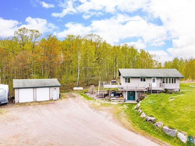 5152 Martin Rd, Duluth, MN 55811 - view of front of property featuring an outdoor structure, a wooden deck, a detached garage, stairs, and a wooded view