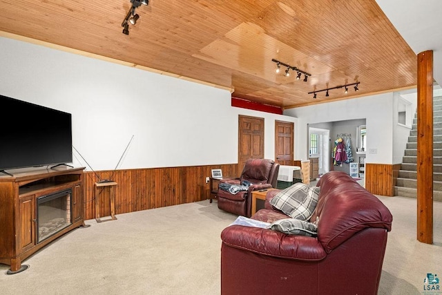5152 Martin Rd, Duluth, MN 55811 - carpeted living room with rail lighting, a wainscoted wall, wooden walls, wood ceiling, and stairway