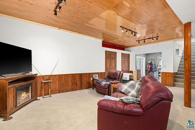 5152 Martin Rd, Duluth, MN 55811 - carpeted living area with rail lighting, a wainscoted wall, wooden walls, wood ceiling, and stairs