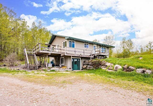 5152 Martin Rd, Duluth, MN 55811 - back of property with a deck, stairs, and stucco siding