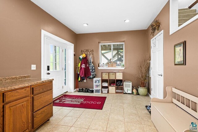 5152 Martin Rd, Duluth, MN 55811 - entryway featuring healthy amount of natural light, light tile patterned flooring, recessed lighting, baseboards, and stairs