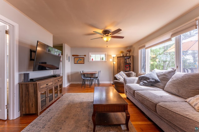 13359 Villa Rd, Ely, MN 55731 - living room featuring ceiling fan, wood finished floors, plenty of natural light, and baseboards
