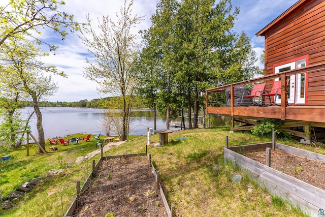 13359 Villa Rd, Ely, MN 55731 - view of yard featuring a vegetable garden and a deck with water view