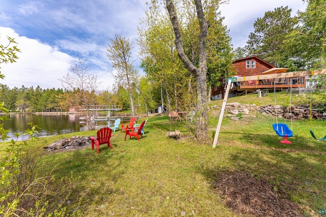 13359 Villa Rd, Ely, MN 55731 - view of green lawn featuring an outdoor fire pit and a deck with water view