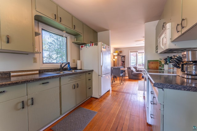 13359 Villa Rd, Ely, MN 55731 - kitchen featuring freestanding refrigerator, a sink, dark countertops, and light wood-style floors