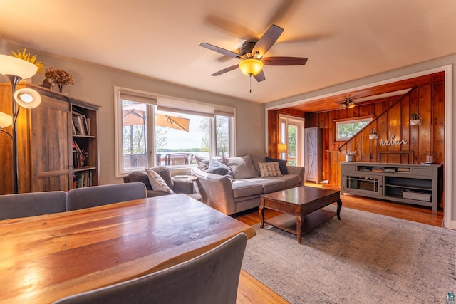 13359 Villa Rd, Ely, MN 55731 - living room featuring a ceiling fan, healthy amount of natural light, wood finished floors, and wood walls