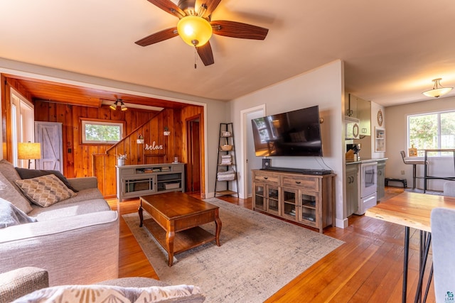 13359 Villa Rd, Ely, MN 55731 - living room featuring ceiling fan, hardwood / wood-style flooring, and wood walls