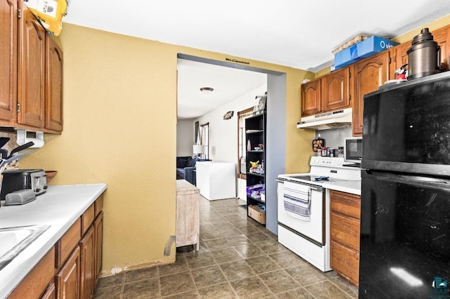 214 5th St, Proctor, MN 55810 - kitchen with freestanding refrigerator, electric range, under cabinet range hood, and brown cabinets