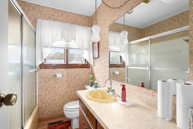 11 Aiken Crk, Silver Bay, MN 55614 - full bathroom featuring vanity, toilet, and shower / bath combination with glass door