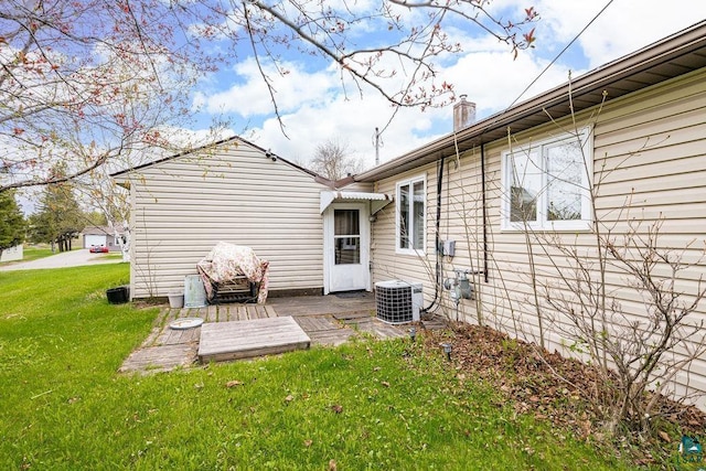 11 Aiken Crk, Silver Bay, MN 55614 - rear view of house featuring a lawn, a wooden deck, central AC unit, and a chimney